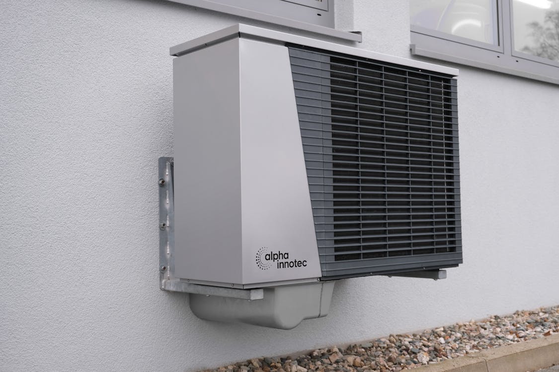 Newly installed residential air conditioning unit on exterior wall